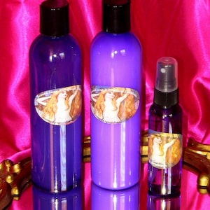 May include: Three bottles of purple liquid with a label featuring a woman with long blonde hair. The bottles are on a gold and white surface.