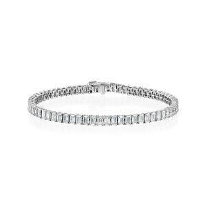 May include: A silver bracelet with a row of rectangular-cut, clear gemstones. The bracelet is clasped and lies on a white background. The gemstones are set closely together, creating a continuous sparkle.