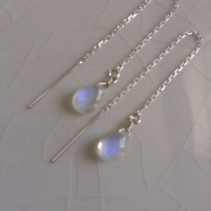 May include: A pair of silver chain earrings with iridescent moonstone teardrop pendants.