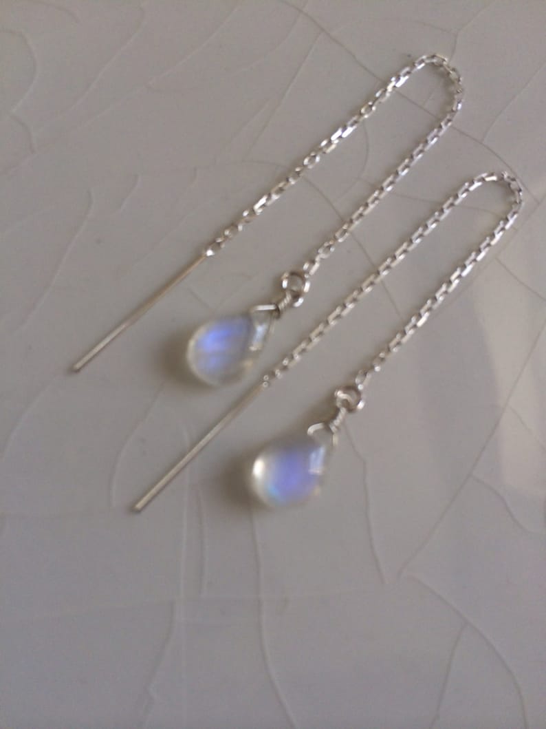 May include: A pair of silver chain earrings with iridescent moonstone teardrop pendants.