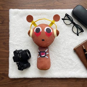 May include: A set of three ceramic mugs with a speckled, matte finish. The mugs are in shades of cream, light gray, and dark gray. Each mug has a simple, minimalist design, perfect for coffee or tea.