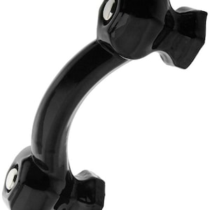 May include: A black, curved cabinet pull with a glossy finish. The pull has a rounded, ergonomic design with two mounting points, each featuring a silver-colored screw head. The overall shape is reminiscent of a stylized handle.