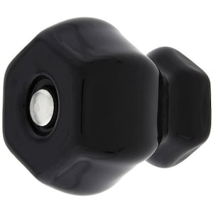 May include: A black ceramic cabinet knob with a hexagonal shape. The knob has a smooth, glossy finish.