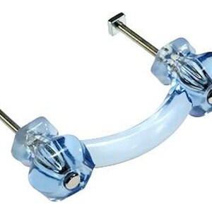 May include: A clear blue cabinet pull with a curved, light blue handle. The pull has faceted, jewel-like ends with silver hardware. The handle is approximately 4 inches long, perfect for adding a touch of elegance to furniture.
