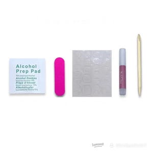 May include: A nail kit containing an alcohol prep pad, a pink nail file, nail adhesive tabs, nail glue, and a wooden cuticle pusher. The alcohol prep pad has text in English, Dutch, and French.