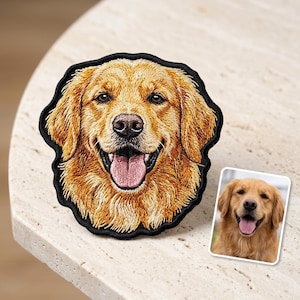May include: Embroidered patch featuring a smiling golden retriever dog with a black border. The patch showcases the dog's light brown fur, pink tongue, and detailed facial features. A smaller image of the dog is also present.