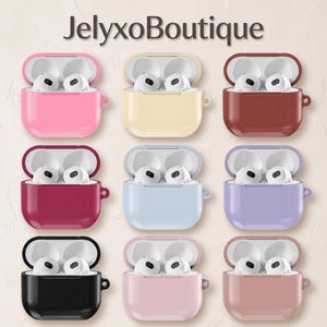 May include: Nine open earbud charging cases in various solid colors including pink, cream, brown, dark red, light blue, purple, black, light pink, and dusty rose, each containing white earbuds. The text JelyxoBoutique is centered at the top.
