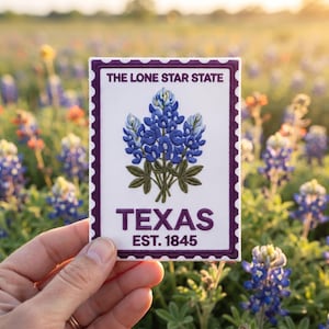 May include: A rectangular embroidered patch featuring a white background with a dark purple scalloped border. The design includes a bluebonnet flower illustration, the text THE LONE STAR STATE, TEXAS, and EST. 1845 in dark purple lettering.