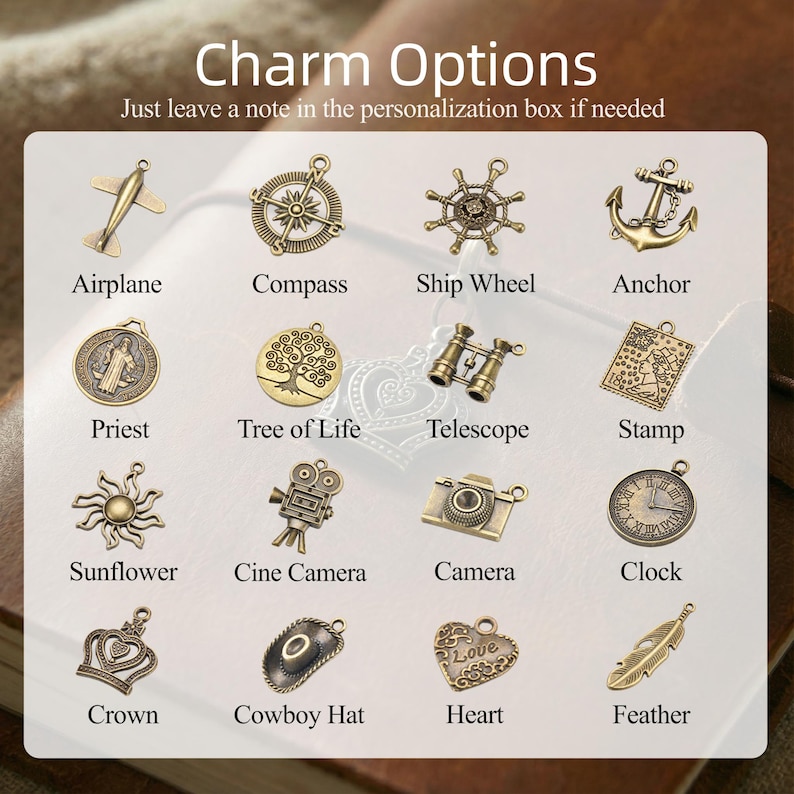 May include: A collection of sixteen antique bronze-toned metal charms arranged in a grid. The charms include an airplane, compass, ship wheel, anchor, priest, tree of life, telescope, stamp, sunflower, cine camera, camera, clock, crown, cowboy hat, heart, and feather.