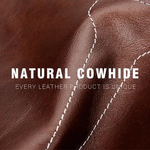 May include: Close-up of brown natural cowhide leather with white stitching. The image includes the text "NATURAL COWHIDE" and "EVERY LEATHER PRODUCT IS UNIQUE". The leather has a rich, textured appearance.