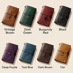 May include: Eight rectangular journals with elastic closures and metal charms, labeled Vintage Brown, Dark Green, Burgundy Red, Black, Deep Purple, Teal Blue, Dark Brown, and Tan. Each journal features a smooth cover and a secure strap.