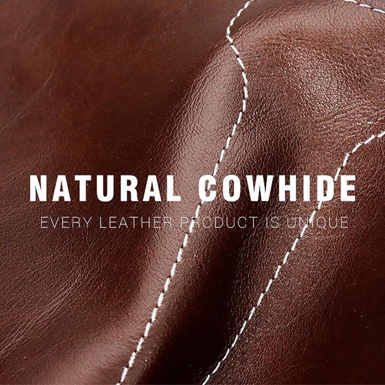 May include: A dark brown cowhide leather surface with a smooth, slightly glossy texture and visible white stitching. The text NATURAL COWHIDE and EVERY LEATHER PRODUCT IS UNIQUE is printed in white across the center of the leather material.