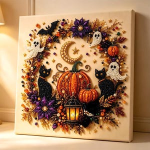 May include: A square canvas art piece featuring a beaded Halloween wreath design. The wreath includes two black cats, white ghosts, orange pumpkins, a glowing lantern, a crescent moon, and purple flowers, all accented with small colorful beads.