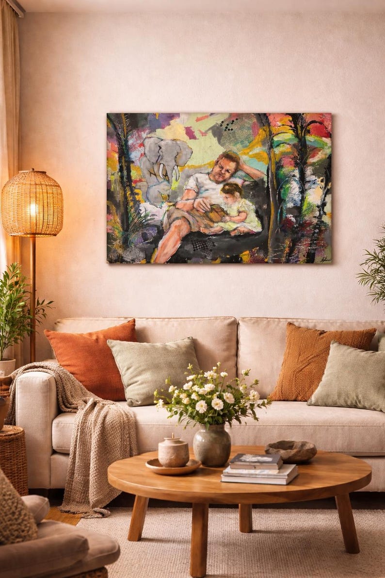 May include: A living room scene featuring a beige sofa with orange and green pillows, a round wooden coffee table, and a woven floor lamp. Above the sofa hangs a colorful painting of a person and child. The room has a warm, inviting atmosphere.