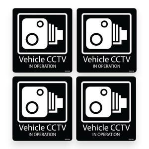May include: Four black and white Vehicle CCTV stickers. Each sticker features a white CCTV camera icon and the text "Vehicle CCTV IN OPERATION". The stickers are square with rounded corners.