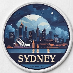May include: A round patch featuring a stylized illustration of the Sydney skyline at night. The design includes the Sydney Opera House, skyscrapers, and the text "SYDNEY AUSTRALIA" in white and navy blue. The patch has a white border.