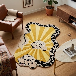 May include: A quirky, yellow rug with a Dalmatian dog design. The rug has a sunburst pattern in yellow and cream, with a black and white spotted border. The dog's face and paws are visible.