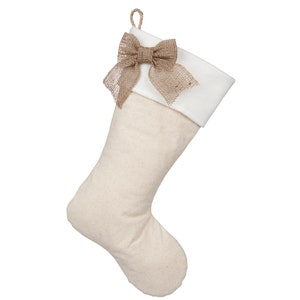 May include: A beige Christmas stocking with a white cuff and a brown hessian bow.