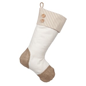 May include: A white Christmas stocking with a brown hessian toe and cuff. The cuff has a brown and white striped fabric with two wooden buttons.