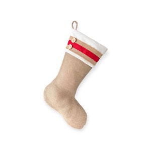 May include: A festive Christmas stocking made from burlap, featuring a white cuff, a red ribbon stripe, and two wooden buttons. It has a jute loop for hanging. The background is white.