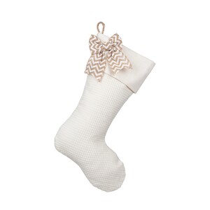 May include: White Christmas stocking with a brown and white chevron bow.