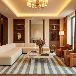 May include: A modern living room with a cream-colored sectional sofa, two brown leather armchairs, and a striped rug in shades of blue and white. The room features built-in wooden shelves, a fireplace, and a marble coffee table.