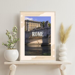 Puede incluir: Impresión enmarcada que presenta una vista panorámica de un puente en Roma, Italia, con el nombre de la ciudad en letras blancas. La imagen muestra un río, edificios y un cielo azul. La impresión se exhibe en una estantería clara con jarrones.