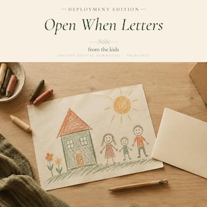 May include: A digital download titled Deployment Edition Open When Letters from the kids. The image features a child's crayon drawing of a house, a sun, and three people, alongside a bowl of crayons, a pencil, and a blank envelope.