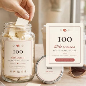 May include: A clear glass jar filled with small folded cream-colored paper notes. The jar features a label with the text 100 little reasons YOU'RE MY BEST FRIEND, decorated with small red hearts and icons. A matching square card is displayed next to the jar.