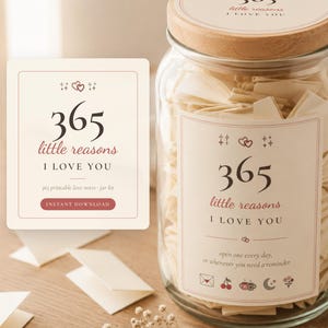 May include: A clear glass jar with a wooden lid filled with small folded cream-colored paper notes. The jar features a label with the text 365 little reasons I LOVE YOU, along with small icons of an envelope, cherries, mugs, moon, and flowers.
