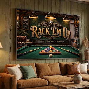 May include: A rectangular wall art print featuring a pool table scene with the text RACK 'EM UP in large gold letters. The image includes a rack of colorful billiard balls, two pool cues, and three hanging pendant lights above a green felt table.