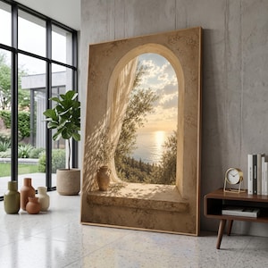 May include: A large rectangular wall art print featuring a textured beige stone archway framing a sunset view over the ocean. A sheer curtain hangs to one side, and a small terracotta vase sits on the stone ledge, with olive tree branches visible.