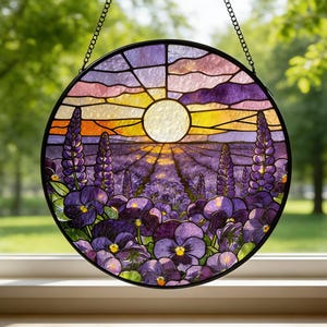 Peut inclure: Une fenêtre ronde en vitrail représentant un coucher de soleil sur un champ de fleurs violettes. Le soleil est un cercle blanc brillant et le ciel passe de l'orange au violet. Les fleurs sont un mélange de violet et de violet.