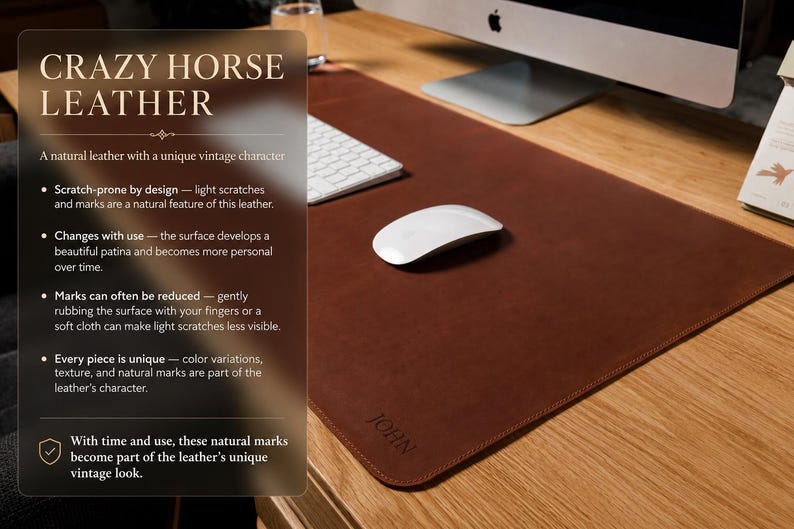 May include: A rectangular brown leather desk mat with rounded corners and the name JOHN embossed in the bottom corner. The mat features a smooth surface texture and is displayed on a wooden desk with a white computer mouse and keyboard.