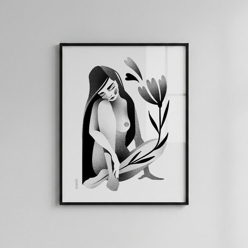 Może przedstawiać: Czarno-biały wydruk artystyczny przedstawiający siedzącą postać z długimi włosami, oprawiony w czarną ramę. Stylizowany kwiat znajduje się po prawej stronie postaci. Grafika ma minimalistyczny styl i nadaje się do dekoracji ścian.