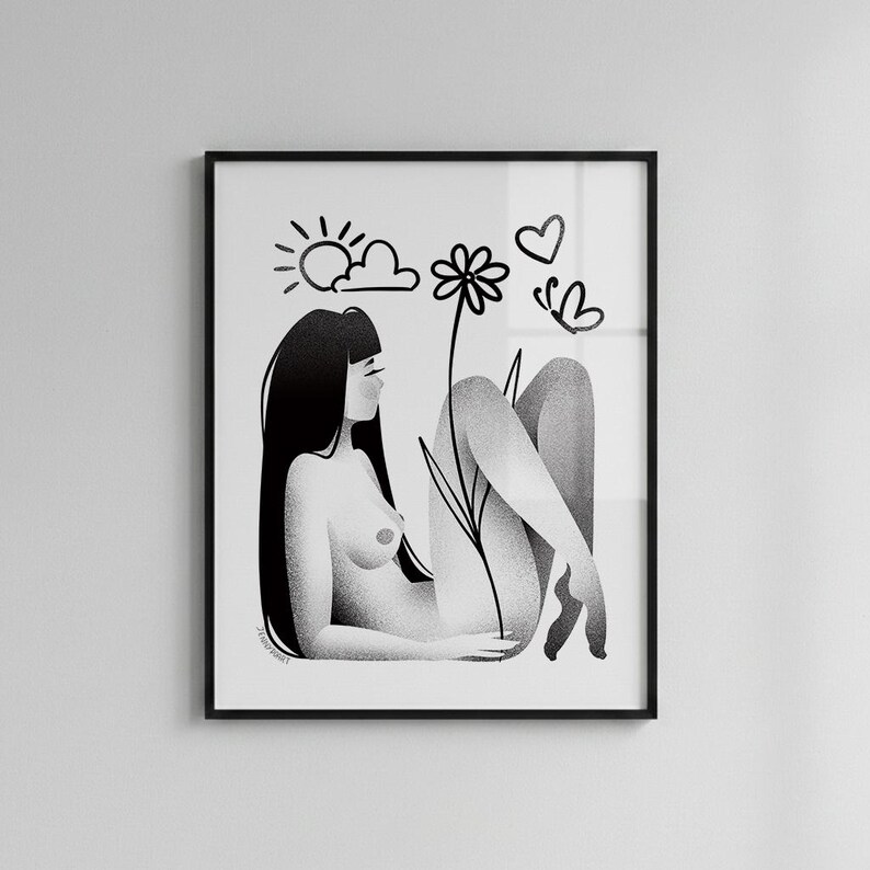 May include: Black and white art print in a black frame. The illustration depicts a person reclining with long black hair, a flower, sun, clouds, a heart, and a butterfly. The artwork has a minimalist style.