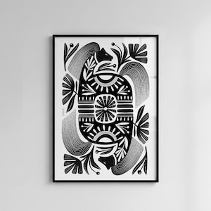 May include: Black and white framed art print featuring a symmetrical design. The artwork includes stylized floral and animal motifs, with intricate patterns and details. The print is set against a white background.