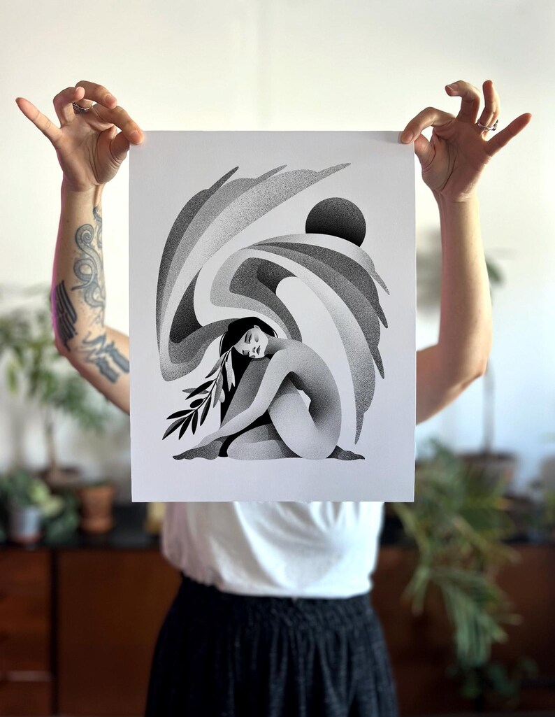 May include: A white ceramic mug with a black handle and the text "But First, Coffee" in a bold, black font. The mug is set against a blurred background, highlighting its simple design.