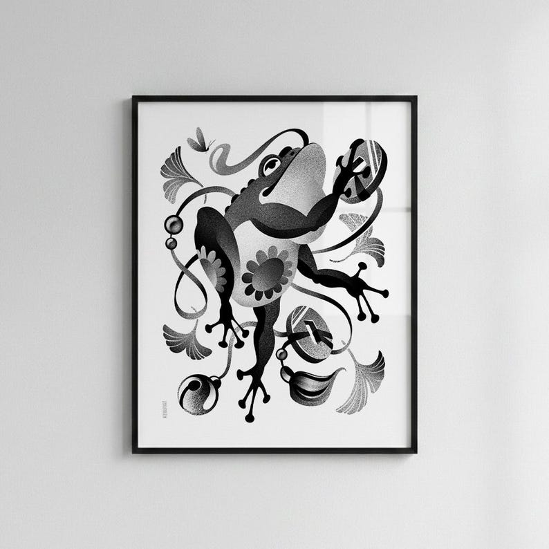 May include: Framed monochrome art print depicting a frog with a floral motif, surrounded by decorative leaves and swirls. The artwork has a whimsical, illustrative style. The frame is black. The print is suitable for a living room or bedroom.