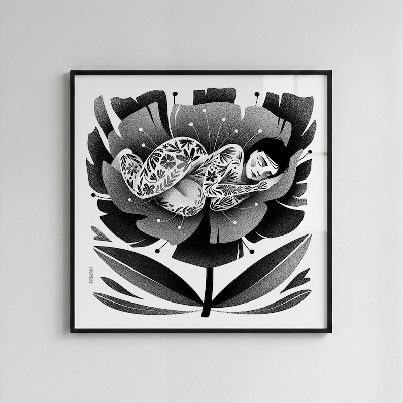May include: Black and white art print of a person sleeping inside a large flower. The person has floral tattoos and is curled up in a peaceful pose. The flower has detailed petals and a stem. The artwork is framed in a black square frame.