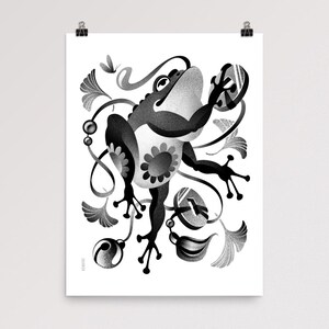 May include: Monochrome art print depicting a stylized frog with a floral pattern on its belly. The frog is set amongst decorative leaves, swirls, and a butterfly. The artwork is printed on white paper.