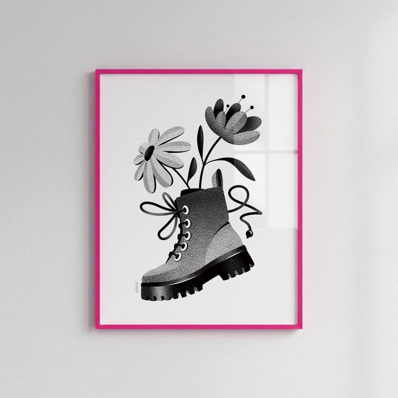 May include: Black and white art print of a combat boot with flowers emerging from the top. The boot is gray with black accents and laces. The artwork is framed in a bright pink frame.