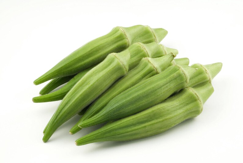May include: A cluster of fresh, vibrant green okra pods arranged together. Each pod features a tapered, elongated shape with a slightly ridged, fibrous texture and a pointed tip, showcasing the natural light green color of the vegetable.