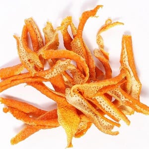 May include: A collection of dried orange peel strips, featuring a vibrant orange exterior with a textured, porous surface and a pale, off-white fibrous interior. The pieces are irregularly shaped, curled, and twisted into various lengths.