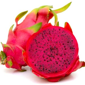 May include: A whole dragon fruit with vibrant pink skin and green-tipped scales positioned next to a halved dragon fruit, revealing a deep magenta flesh speckled with numerous tiny black seeds, all set against a plain white background.