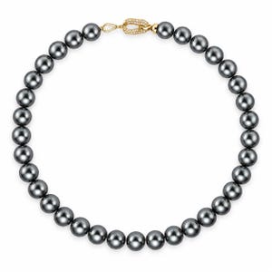 May include: A necklace featuring a continuous strand of round, dark gray pearls. The necklace is secured with a gold-toned oval clasp that is embellished with small, clear, sparkling stones, providing a contrast to the dark, lustrous pearls.
