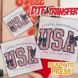 May include: DTF transfer sheets with a patriotic design. The word "USA" is in red and white stripes, with blue bows and stars. The text "250th Anniversary 1776-2026" is also present. The words "Ready to Press" are visible.