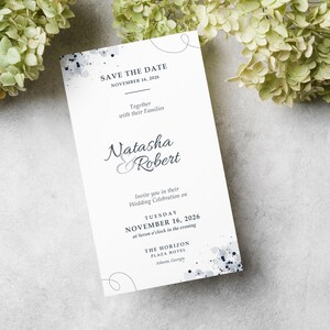 Może przedstawiać: Białe zaproszenie ślubne z niebieskimi akcentami akwarelowymi i tekstem "SAVE THE DATE" na górze. Zaproszenie zawiera imiona "Natasha & Robert", datę "NOVEMBER 16, 2026" oraz lokalizację "THE HORIZON PLAZA HOTEL, Atlanta, Georgia".