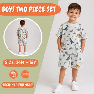 May include: A two-piece set consisting of a short-sleeve t-shirt and shorts in a light gray fabric featuring a repeating pattern of green and brown dinosaurs, palm trees, and mountains. The set includes text reading BOYS TWO PIECE SET.