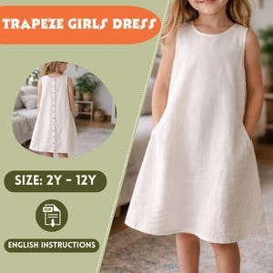 May include: A sleeveless, off-white trapeze dress with pockets, worn by a young girl. The dress has a button-up back. The image includes text that reads "TRAPEZE GIRLS DRESS", "SIZE: 2Y - 12Y", and "ENGLISH INSTRUCTIONS".
